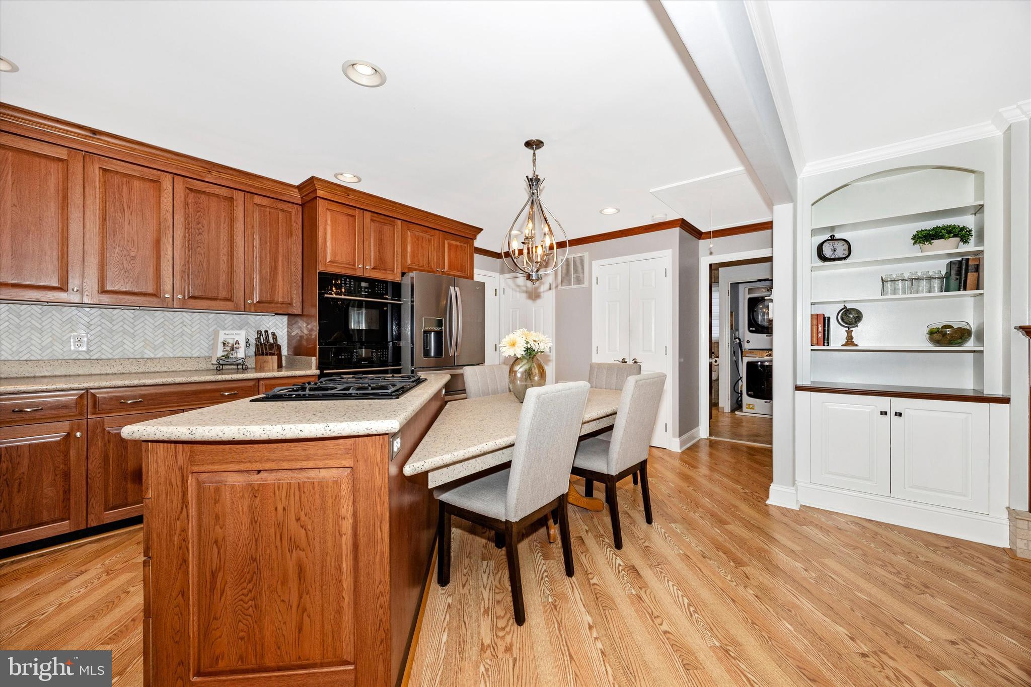 307 Redwood Avenue Frederick, MD 21701 - Photo 8 of 23 a kitchen with stainless steel appliances granite countertop a stove a sink dishwasher and a refrigerator with wooden cabinets
