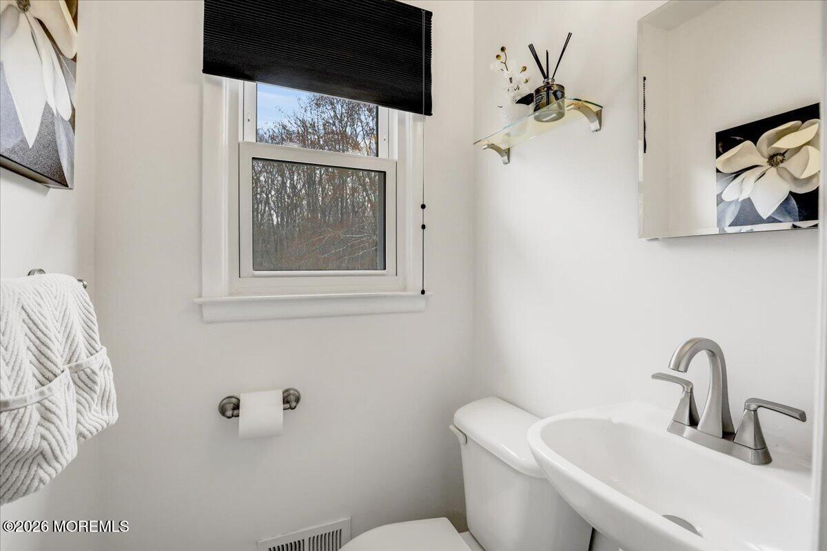 21 Prince William Road Morganville, NJ 07751 - Photo 15 of 39 a bathroom with a toilet sink and mirror