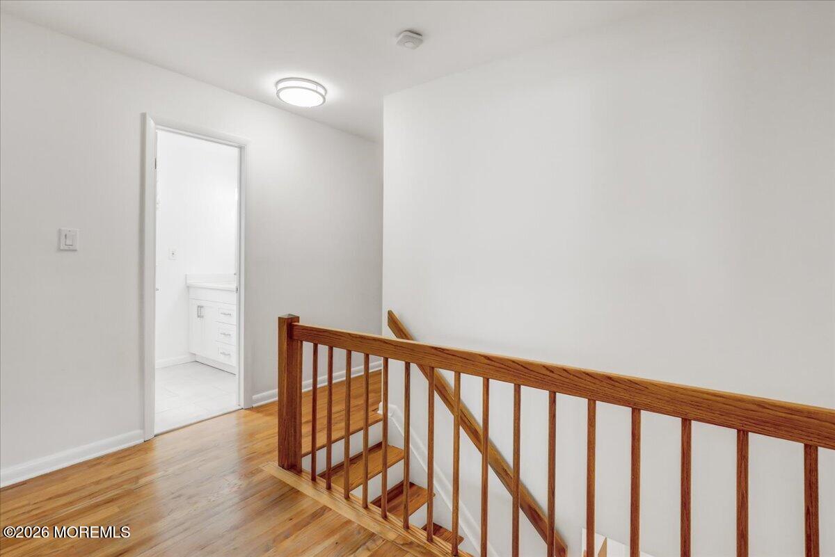 21 Prince William Road Morganville, NJ 07751 - Photo 16 of 39 a view of a hallway with wooden floor