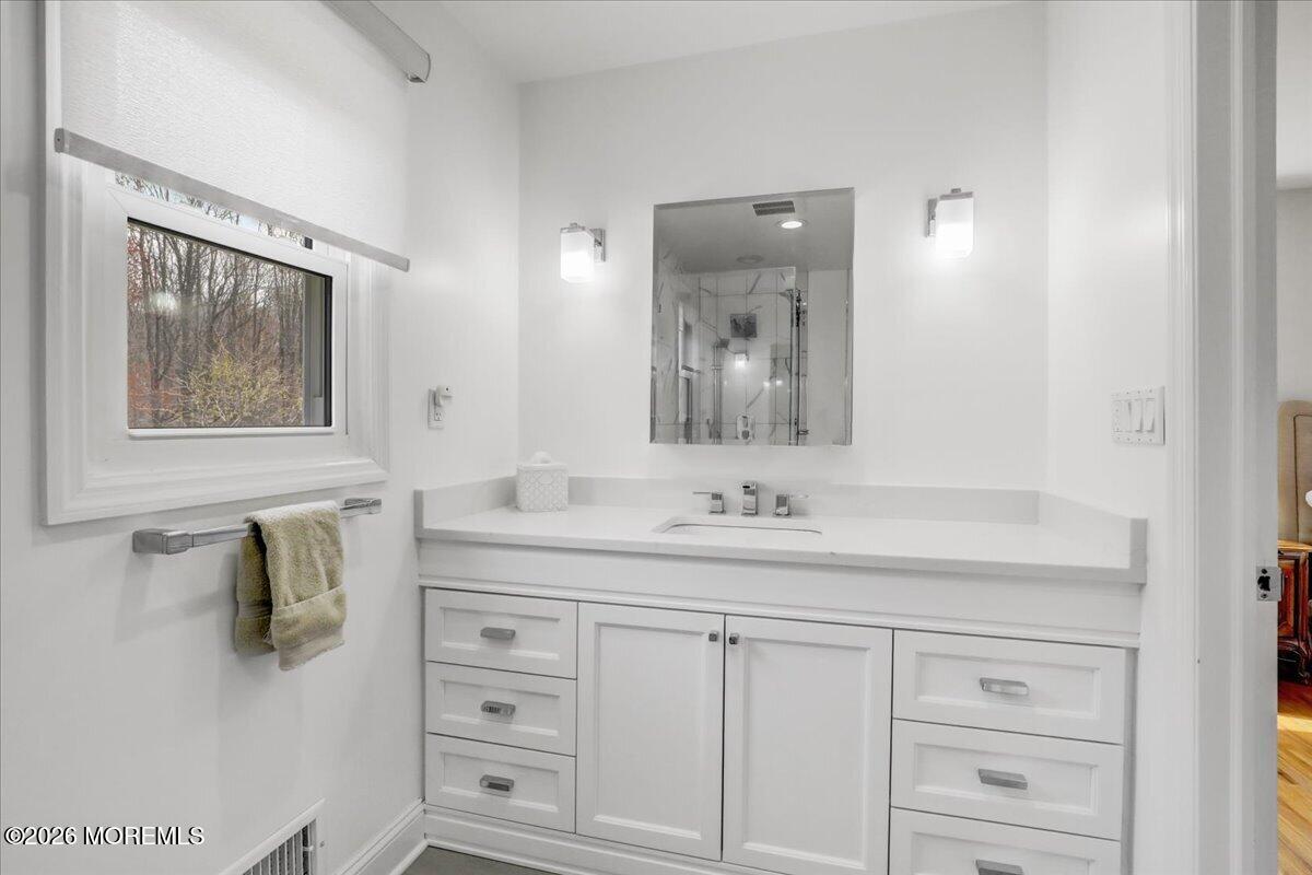 21 Prince William Road Morganville, NJ 07751 - Photo 18 of 39 a bathroom with a sink vanity and mirror