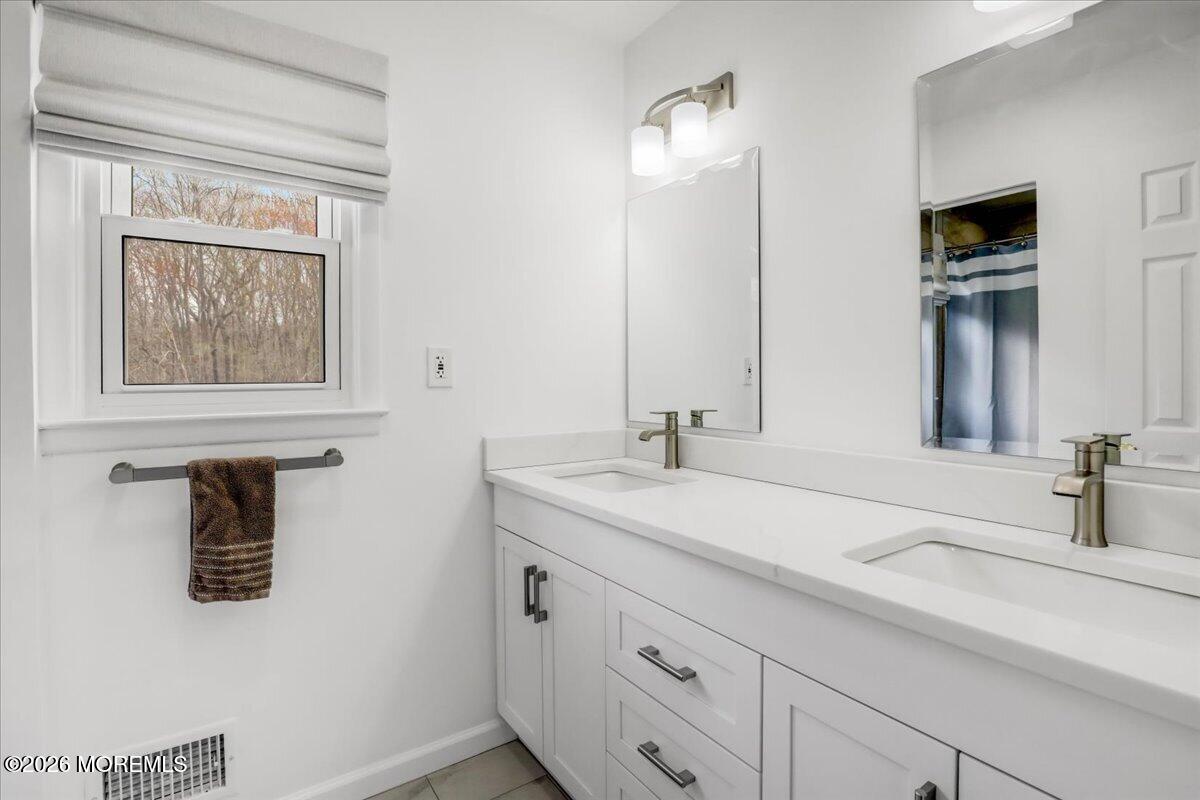 21 Prince William Road Morganville, NJ 07751 - Photo 22 of 39 a bathroom with a sink and a mirror