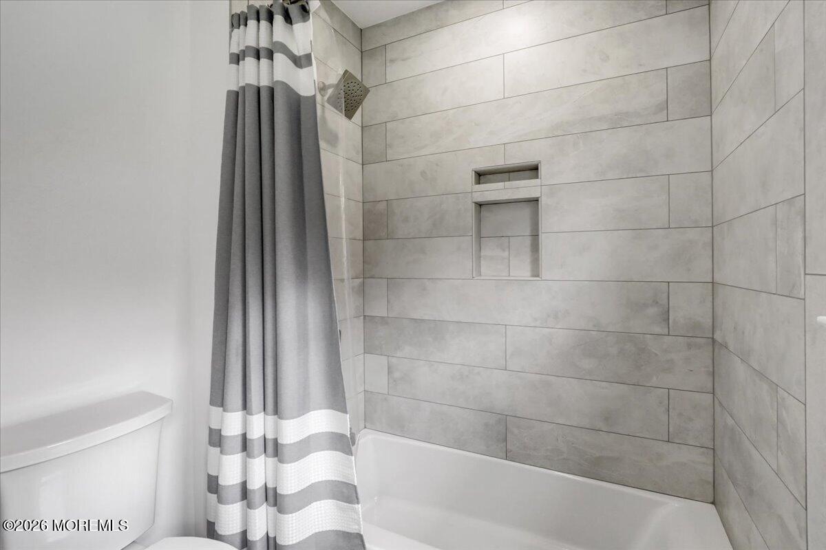 21 Prince William Road Morganville, NJ 07751 - Photo 23 of 39 a bathroom with a bathtub and a shower