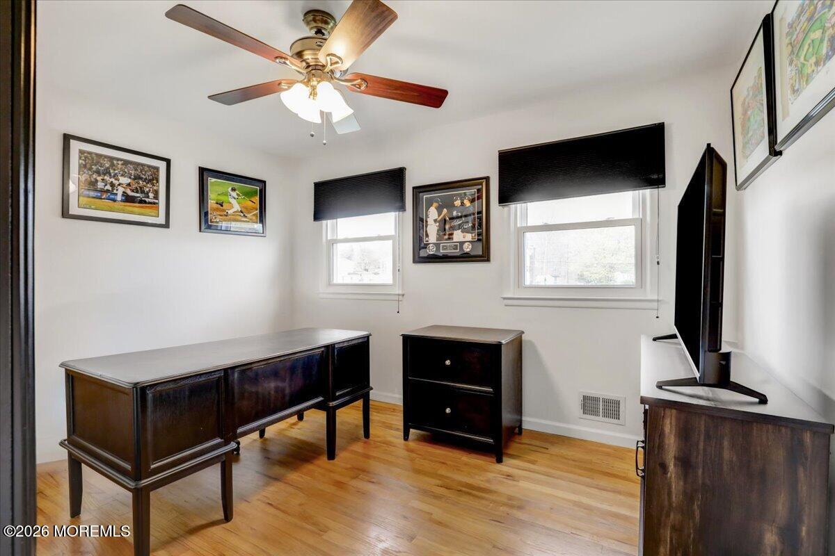 21 Prince William Road Morganville, NJ 07751 - Photo 24 of 39 a living room with furniture and a flat screen tv