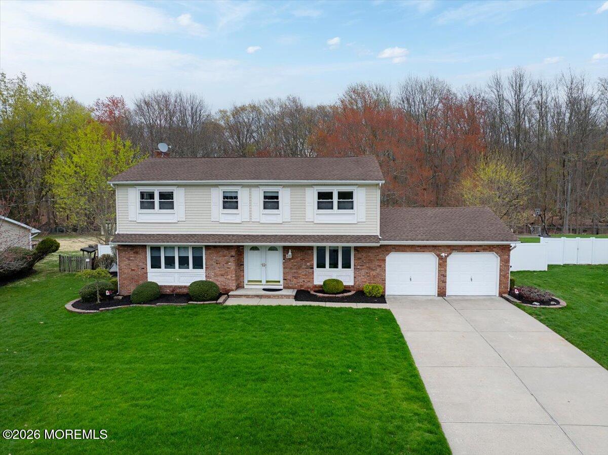 21 Prince William Road Morganville, NJ 07751 - Photo 32 of 39 a front view of house with yard and green space