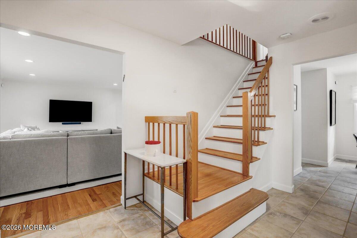 21 Prince William Road Morganville, NJ 07751 - Photo 4 of 39 a view of room with stairs and wooden floor