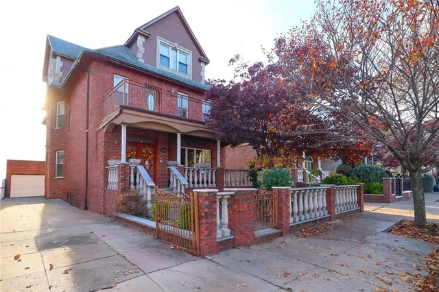 a view of a house with a wooden fence