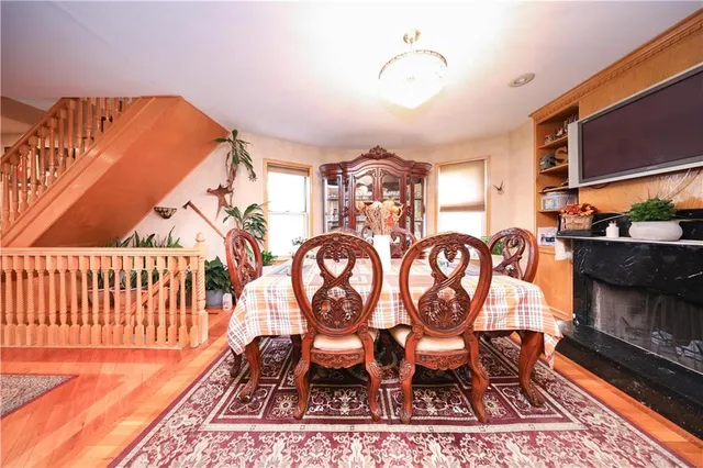 a dining room with furniture and wooden floor