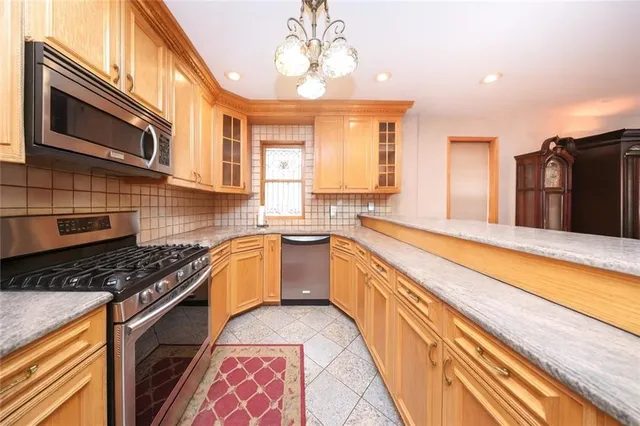 a kitchen with stainless steel appliances granite countertop a sink and cabinets
