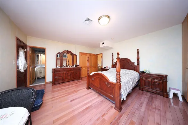 a bedroom with a bed furniture and a large window