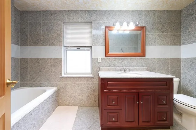 a bathroom with a sink a vanity and bathtub