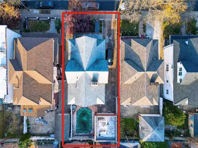 aerial view of a house with a yard and large tree