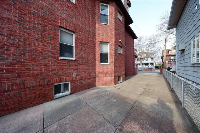 a view of a brick building with many windows