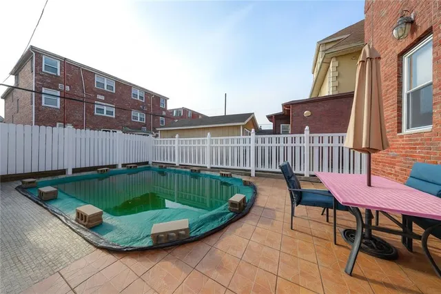 a view of a chairs and table in the backyard