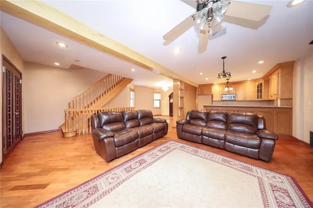a living room with furniture and a chandelier