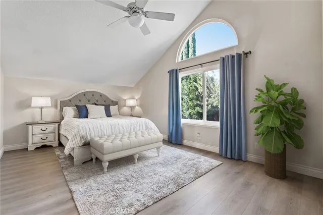 a bedroom with a bed and a potted plant