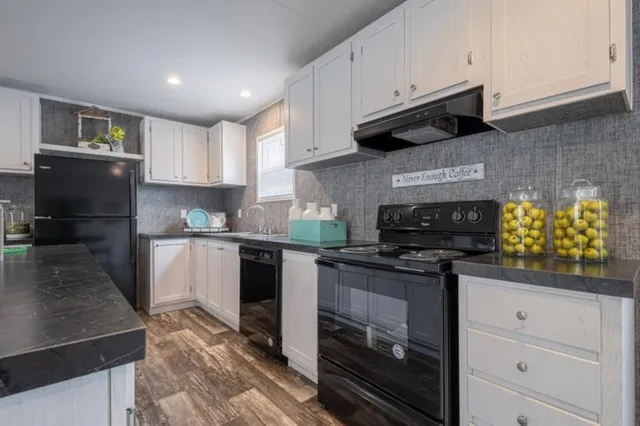 a kitchen with kitchen island a counter top space a sink stainless steel appliances and cabinets