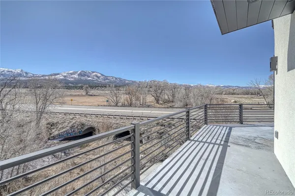 a view of a house with a yard and mountain view