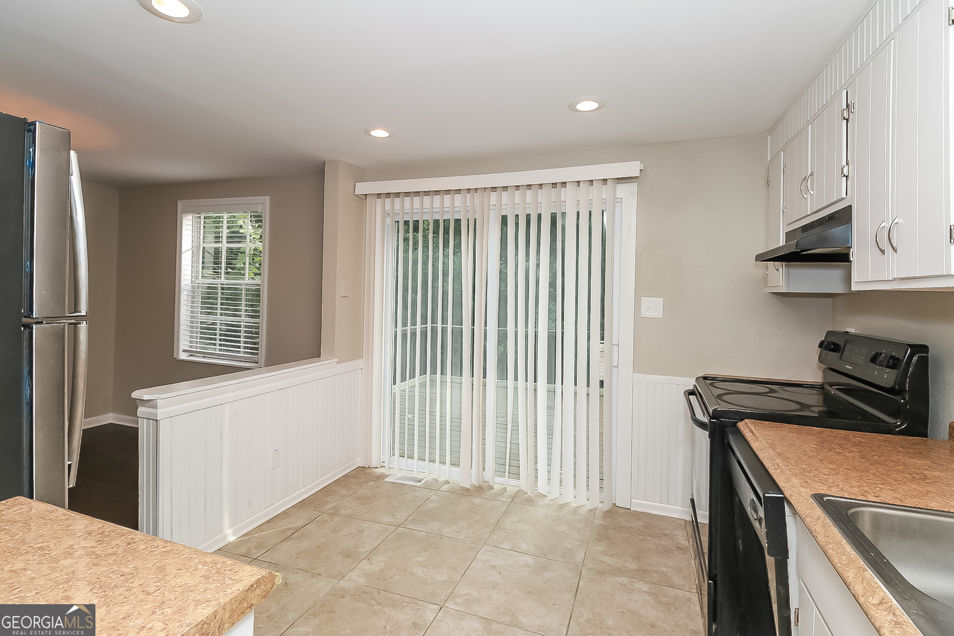 3100 Forestside Court Atlanta, GA 30349 - Photo 4 of 17 a view of a kitchen with an empty space and a window