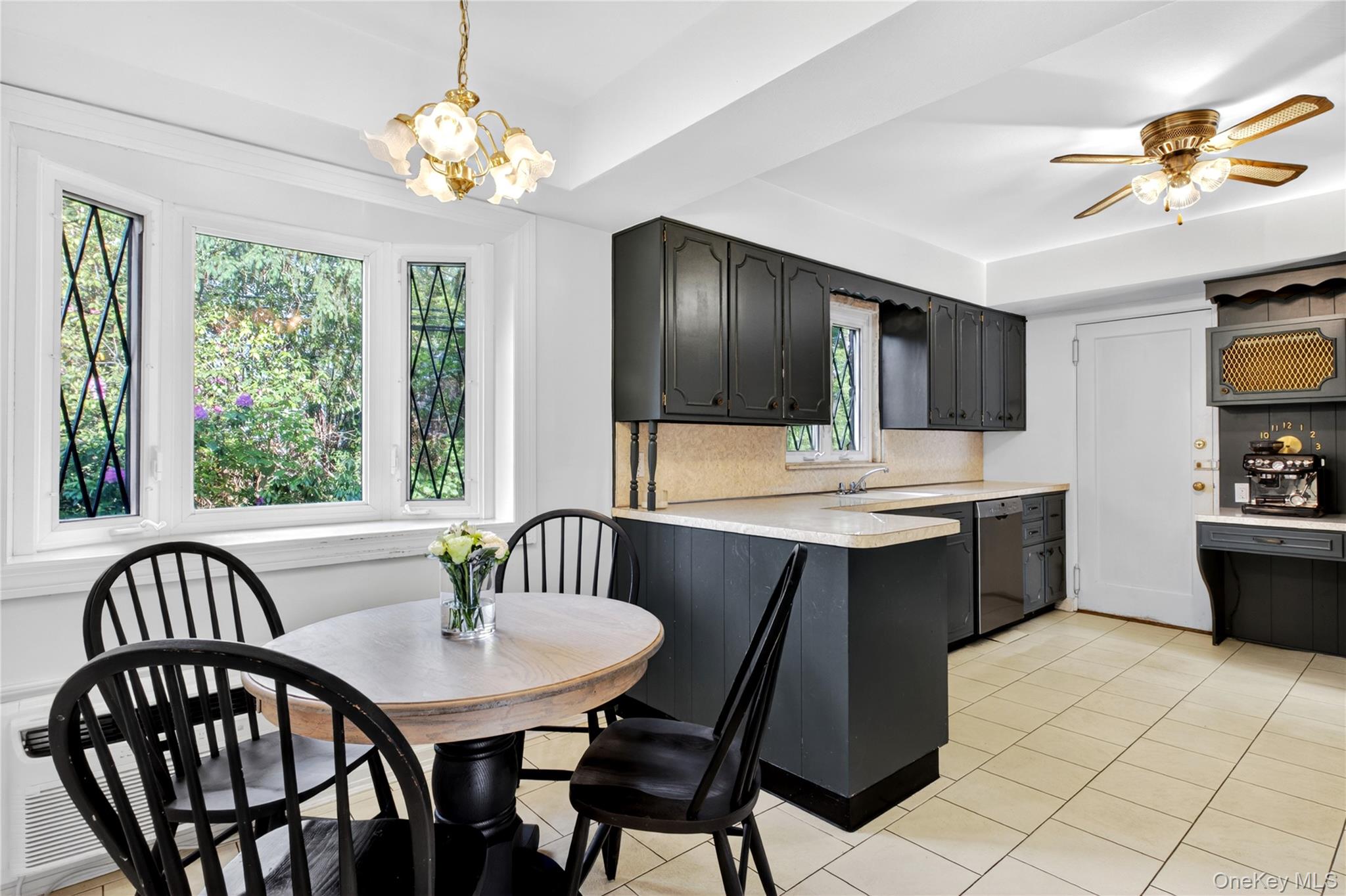 142 Mill Spring Road Manhasset, NY 11030 - Photo 10 of 23 a kitchen with a table chairs sink and cabinets