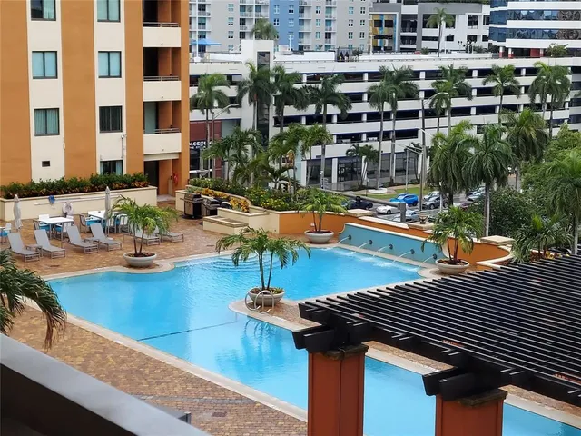 a view of a swimming pool with outdoor seating and plants