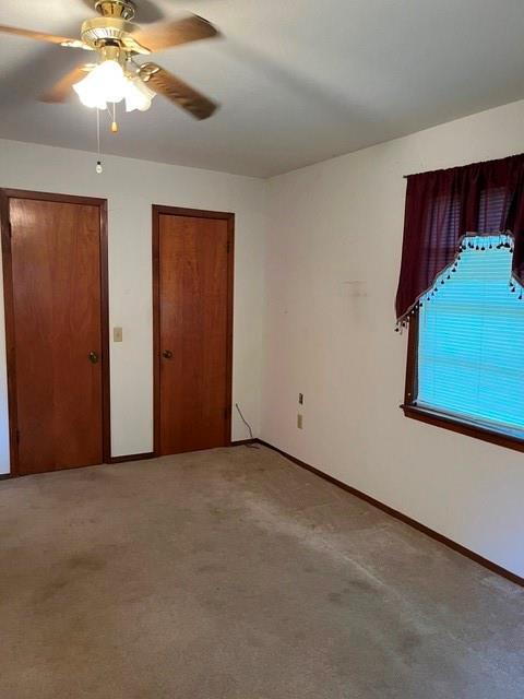 304 Sunset Street Roxton, TX 75477 - Photo 12 of 31 an empty room with windows and fan
