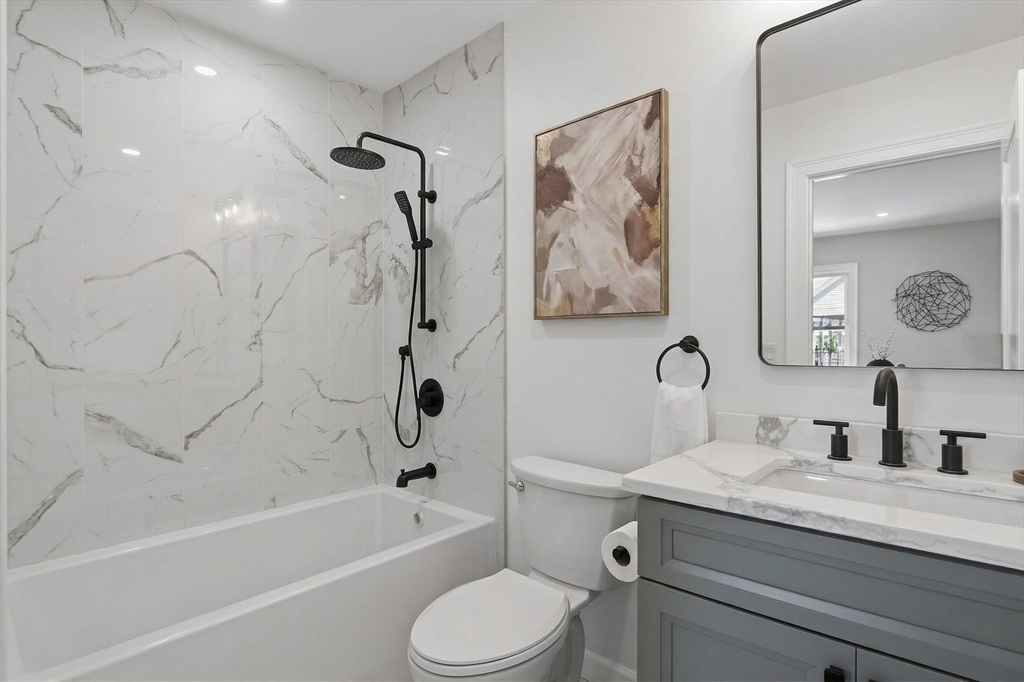 5 Springdale Avenue Saugus, MA 01906 - Photo 14 of 26 a bathroom with a granite countertop sink a toilet and a bathtub