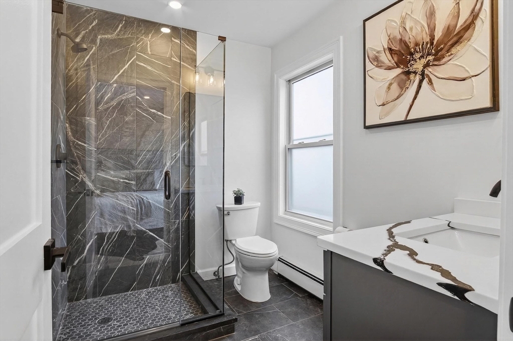 5 Springdale Avenue Saugus, MA 01906 - Photo 16 of 26 a bathroom with a granite countertop sink a toilet and a shower