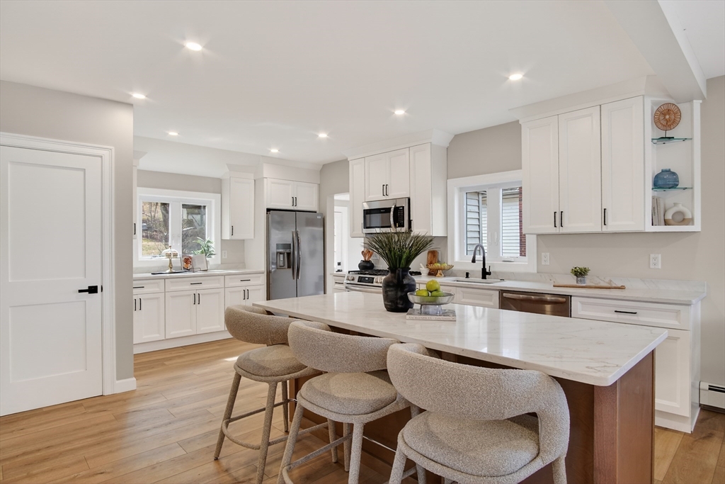 5 Springdale Avenue Saugus, MA 01906 - Photo 3 of 26 a kitchen with stainless steel appliances granite countertop a stove a sink a refrigerator dining table and chairs