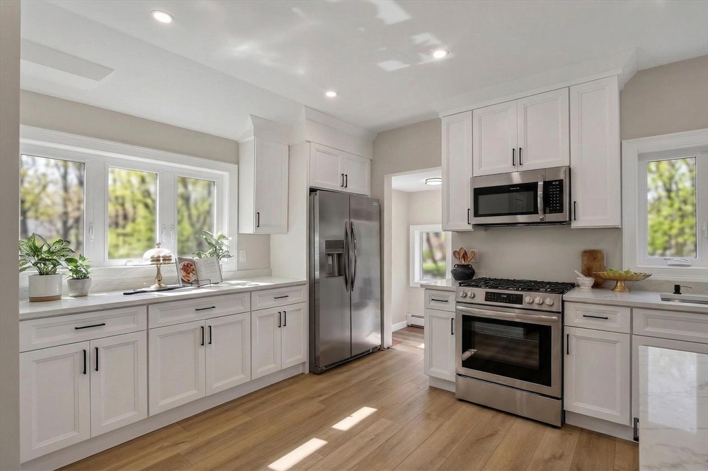 5 Springdale Avenue Saugus, MA 01906 - Photo 7 of 26 a kitchen with a sink stove and refrigerator