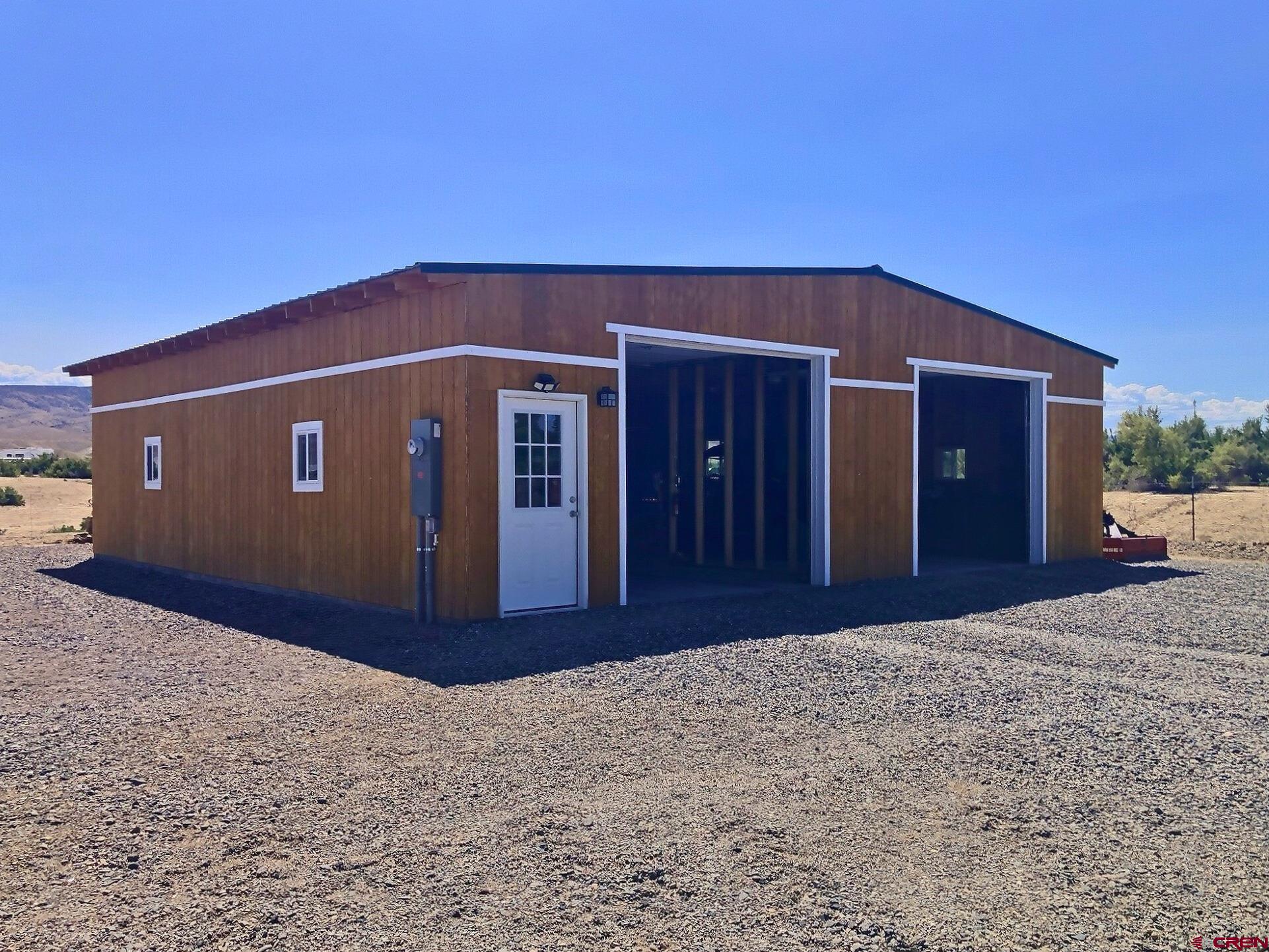 5676 Peach Valley Road Delta, CO 81416 - Photo 9 of 31 built in 2025, 38' x 40 4 car garage, automatic door openers, 4" concrete, 220 electrical service.