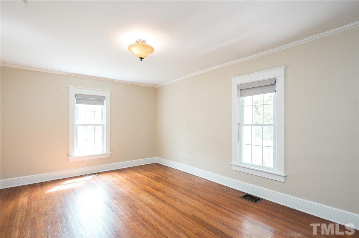 511 Frank Street Raleigh, NC 27604 - Photo 16 of 26 an empty room with wooden floor and windows