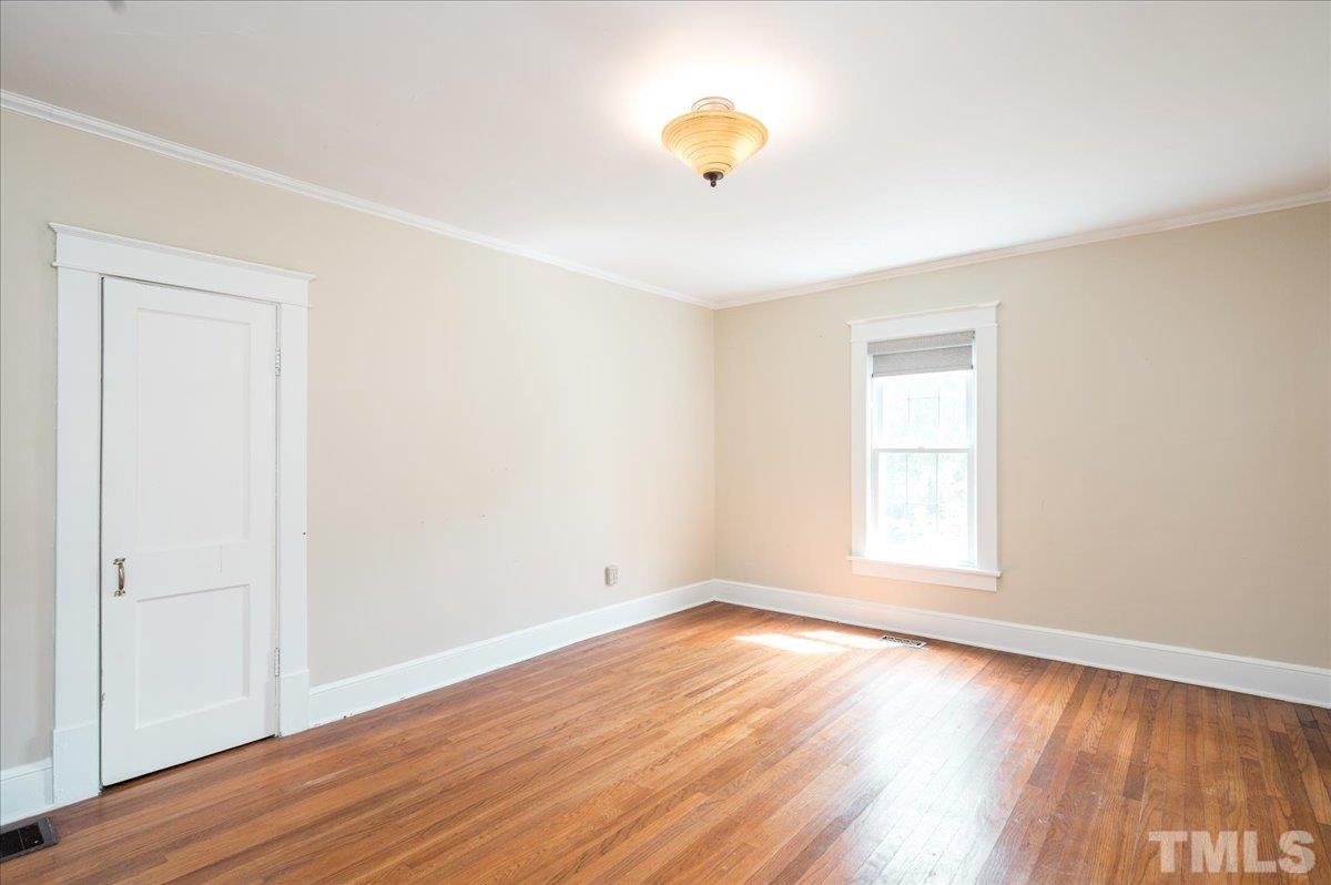 511 Frank Street Raleigh, NC 27604 - Photo 17 of 26 an empty room with wooden floor and windows