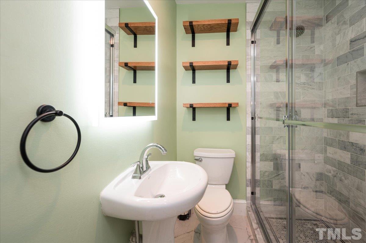 511 Frank Street Raleigh, NC 27604 - Photo 18 of 26 a bathroom with a toilet a sink and mirror