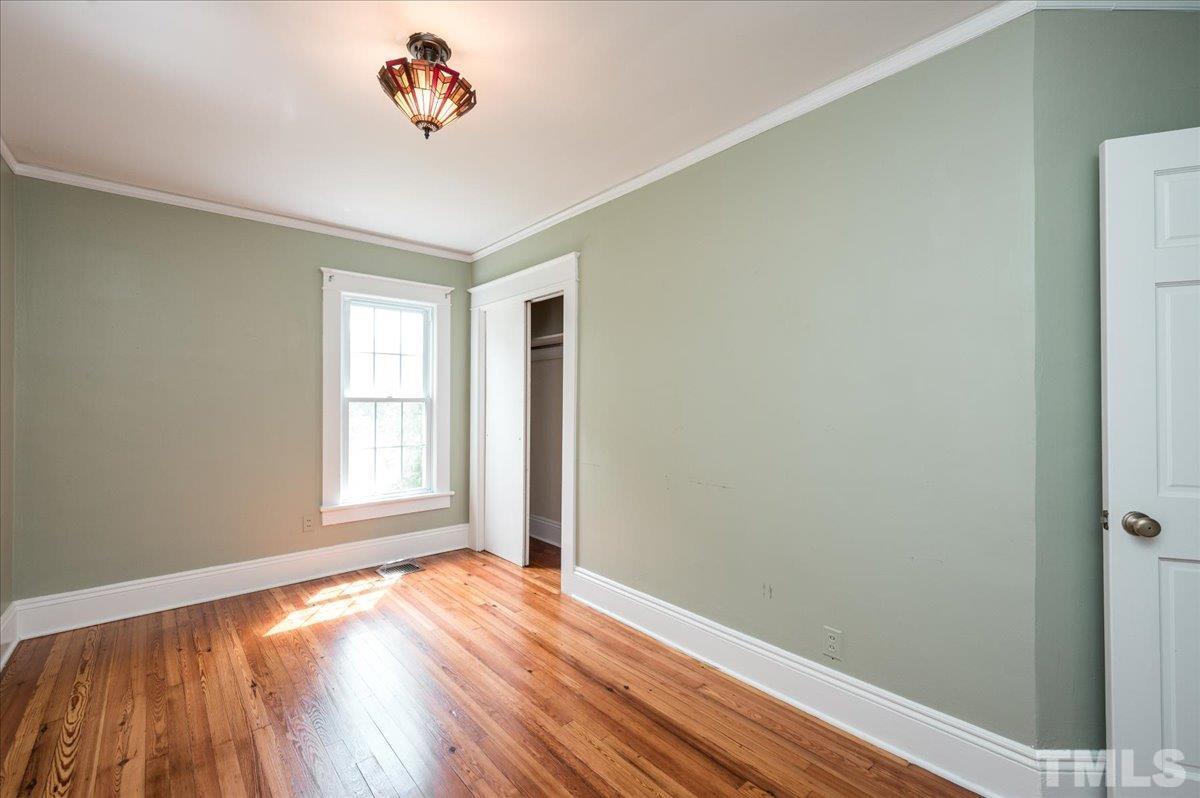 511 Frank Street Raleigh, NC 27604 - Photo 21 of 26 an empty room with wooden floor and windows