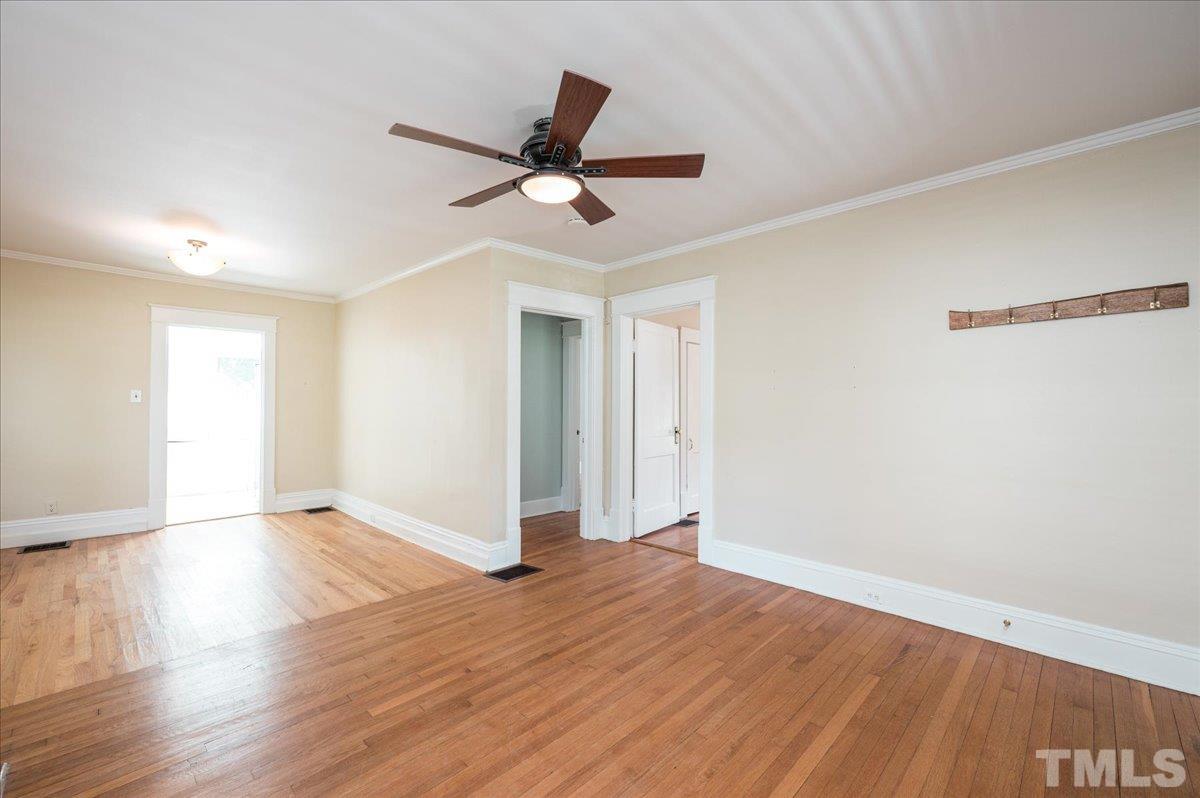 511 Frank Street Raleigh, NC 27604 - Photo 5 of 26 a view of empty room with wooden floor and fan