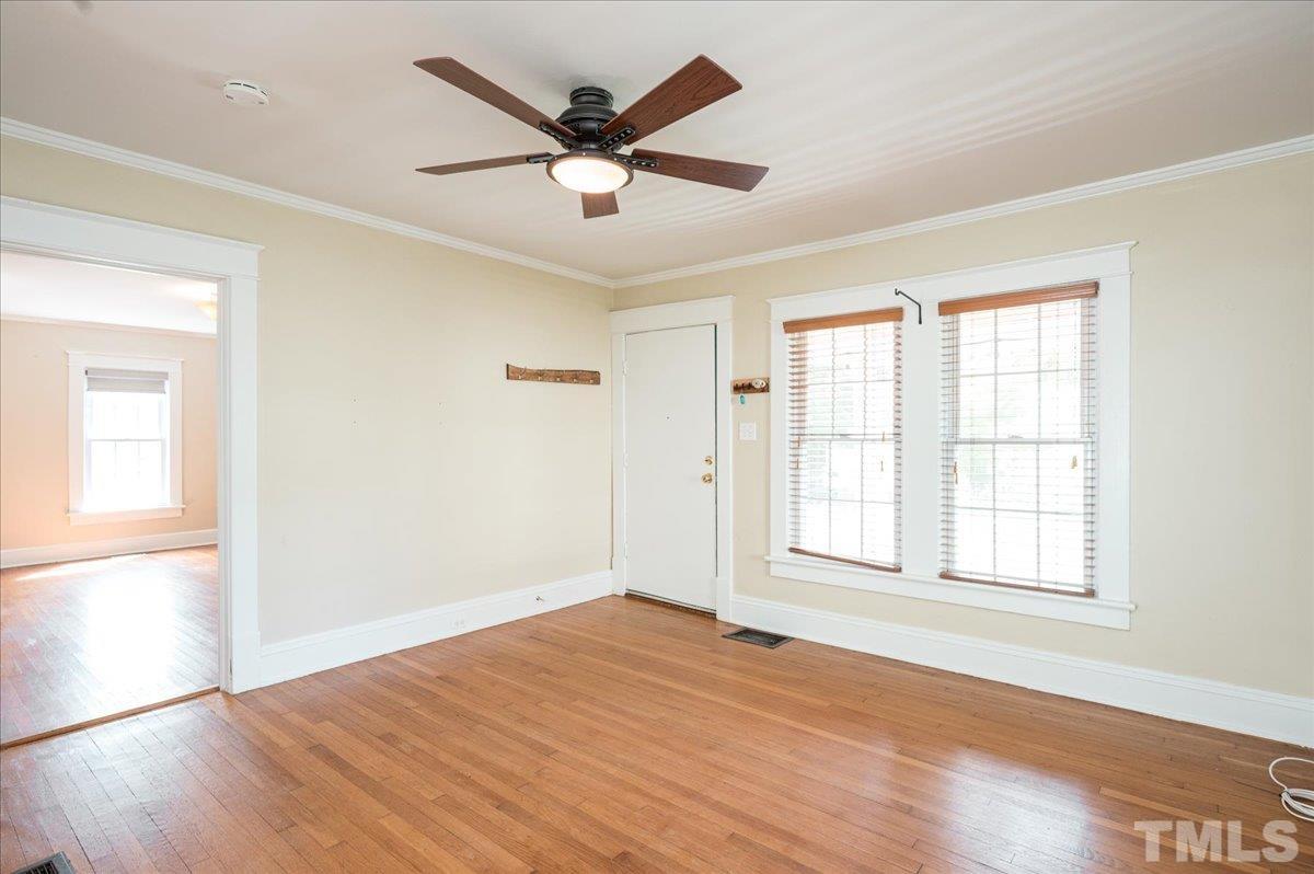 511 Frank Street Raleigh, NC 27604 - Photo 6 of 26 an empty room with wooden floor and windows