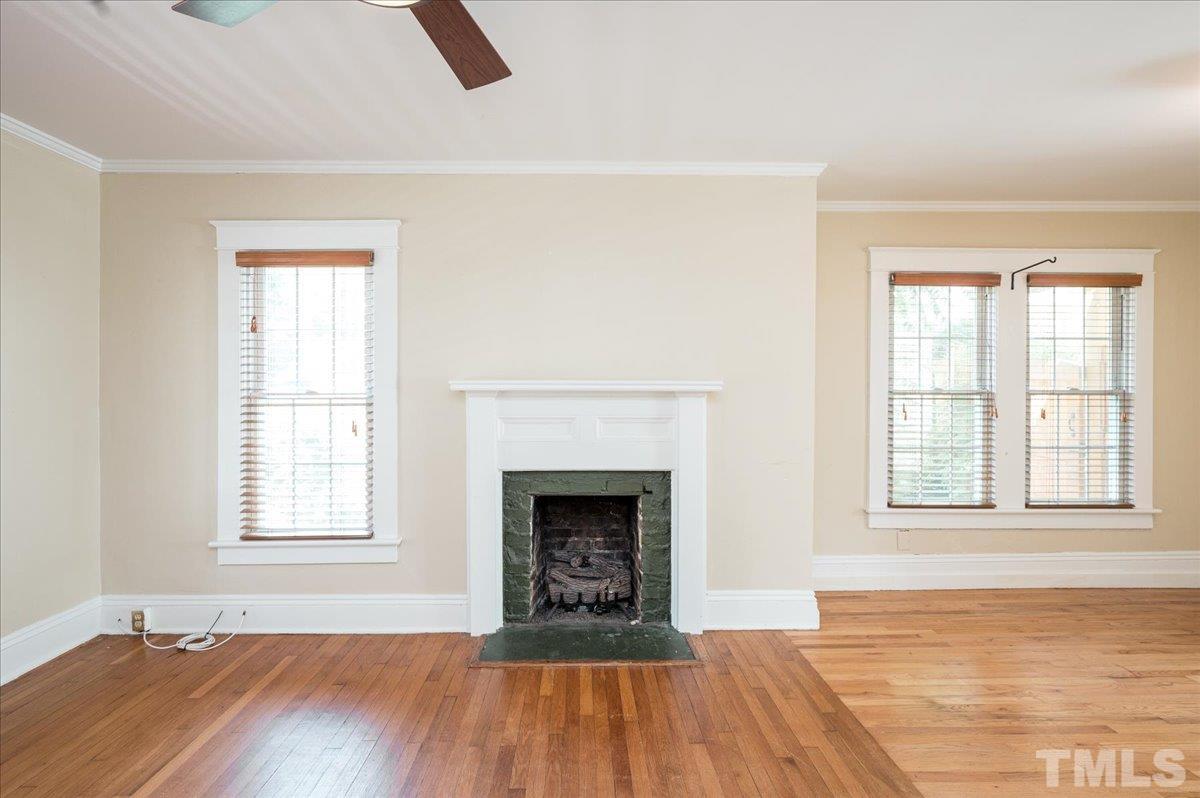 511 Frank Street Raleigh, NC 27604 - Photo 7 of 26 an empty room with windows and fireplace