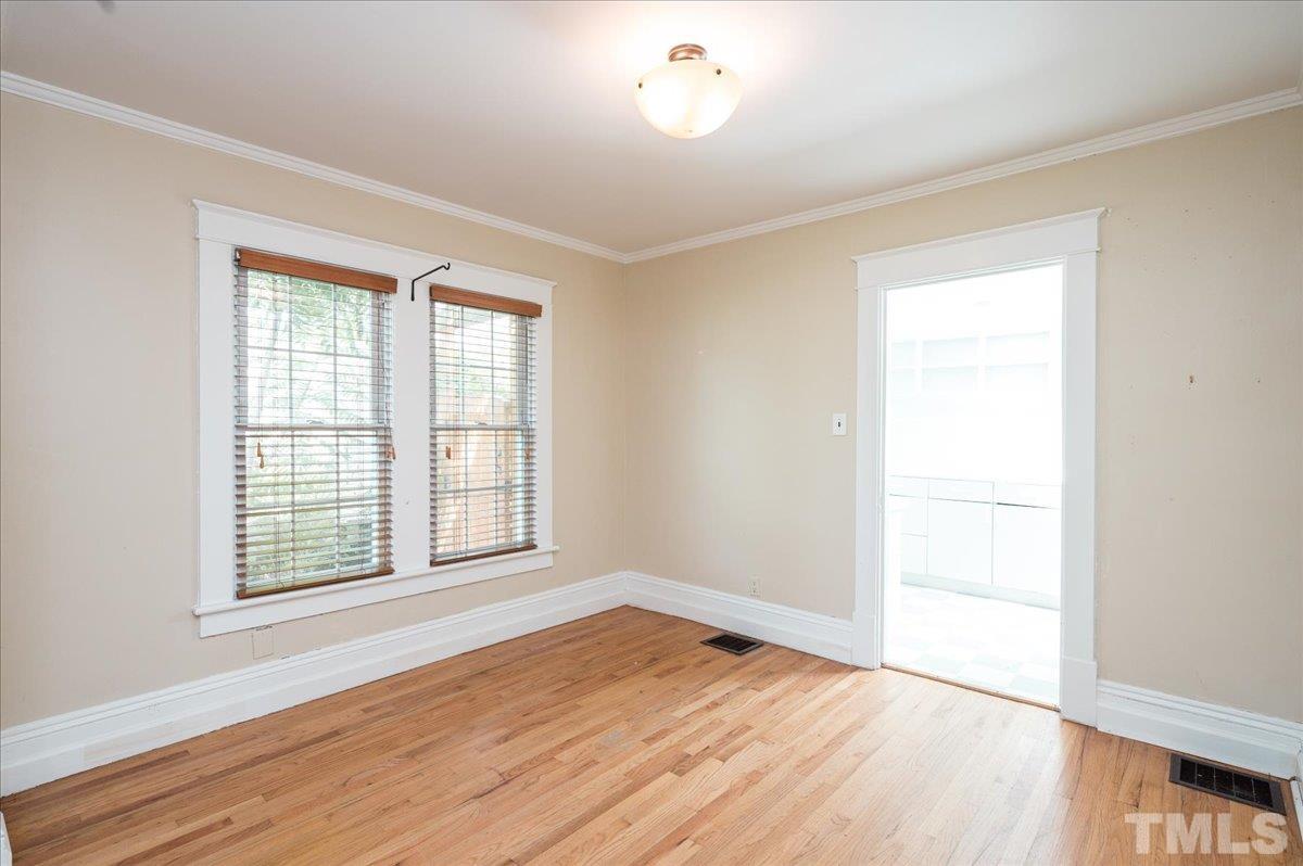 511 Frank Street Raleigh, NC 27604 - Photo 8 of 26 an empty room with wooden floor and windows