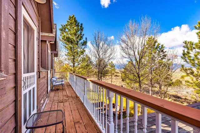 a view of balcony with wooden floor and fence