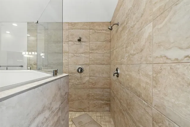 a bathroom with a bathtub and shower