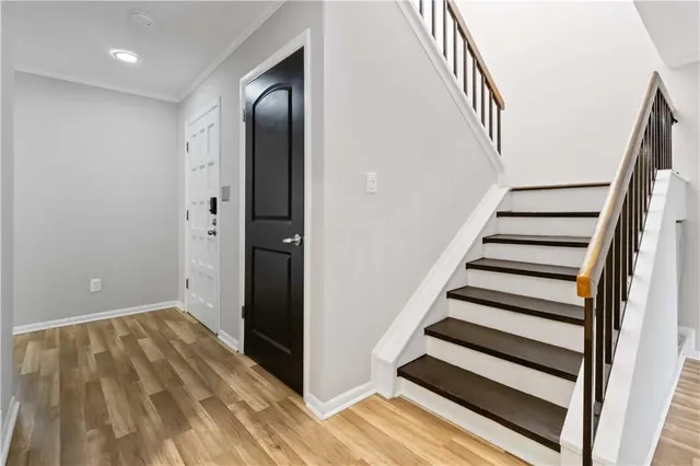 a view of entryway with wooden floor and stairs