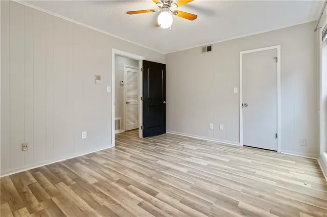 a view of an empty room with a ceiling fan
