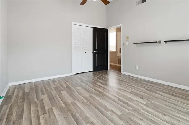a view of an empty room with wooden floor