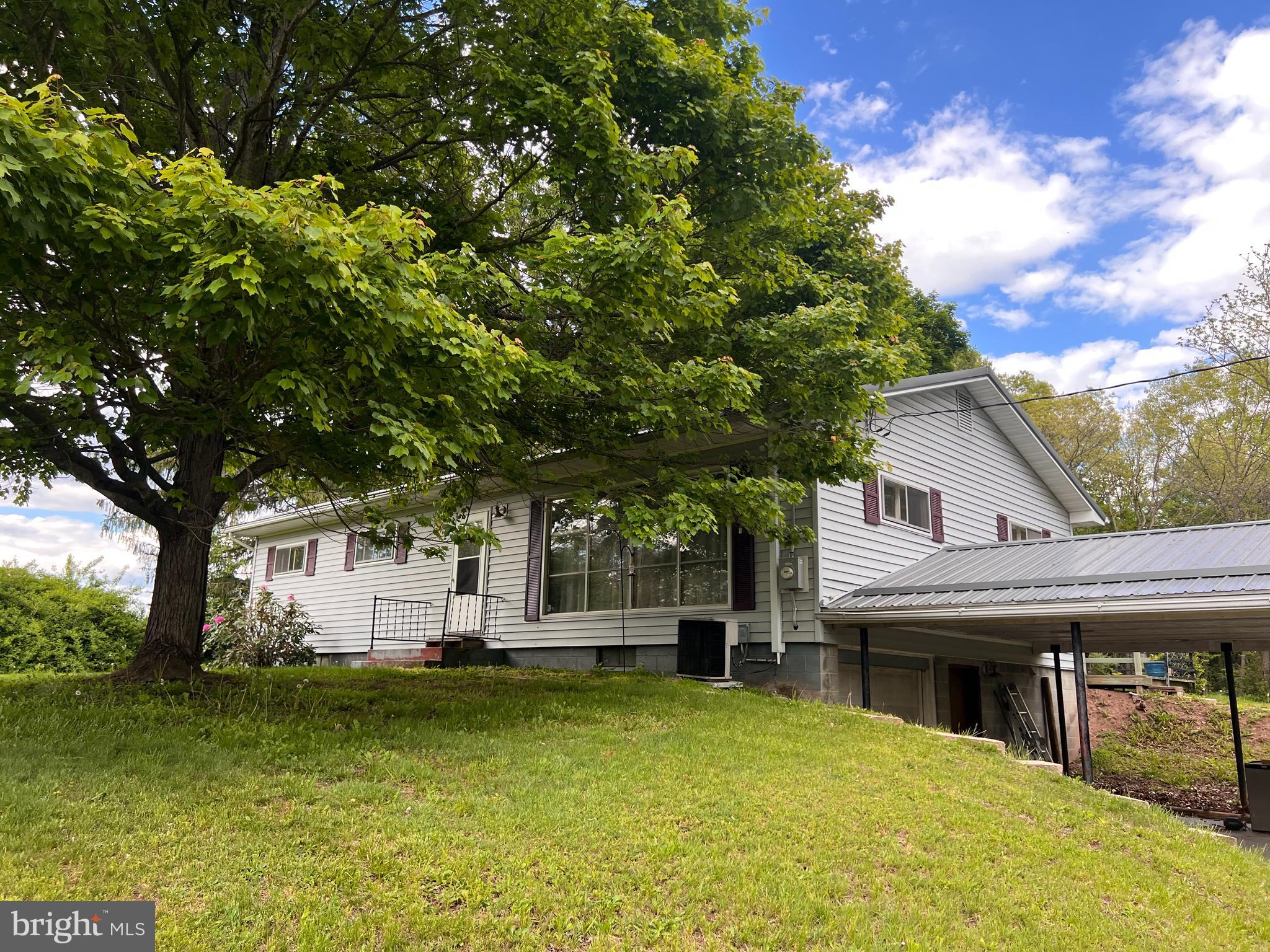 5156 Peach Orchard Road McConnellsburg, PA 17233 - Photo 1 of 34 a house view with swimming pool in front of it