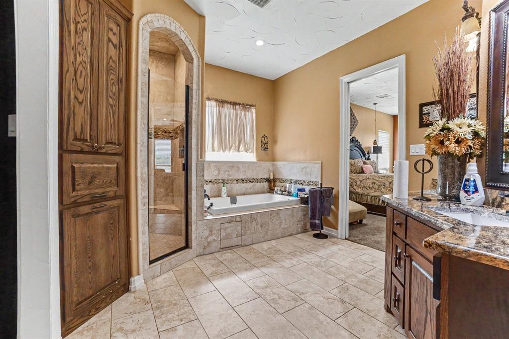 505 South Bluegrove Road Lancaster, TX 75146 - Photo 14 of 37 a large bathroom with a tub and shower