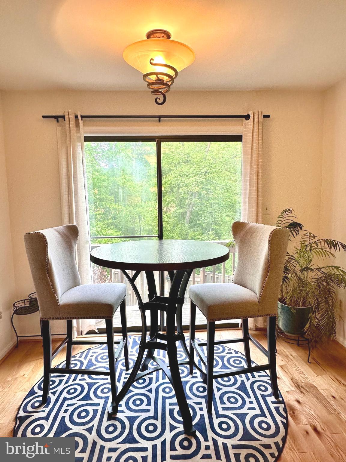 7929 Valleyfield Drive Springfield, VA 22153 - Photo 12 of 39 a view of a dining room with furniture wooden floor and chandelier