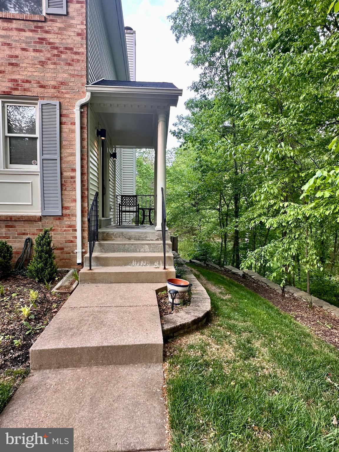 7929 Valleyfield Drive Springfield, VA 22153 - Photo 3 of 39 a view of a backyard with table and chairs and potted plants