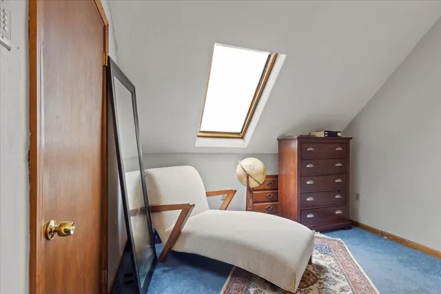 a bedroom with a bed window and chair