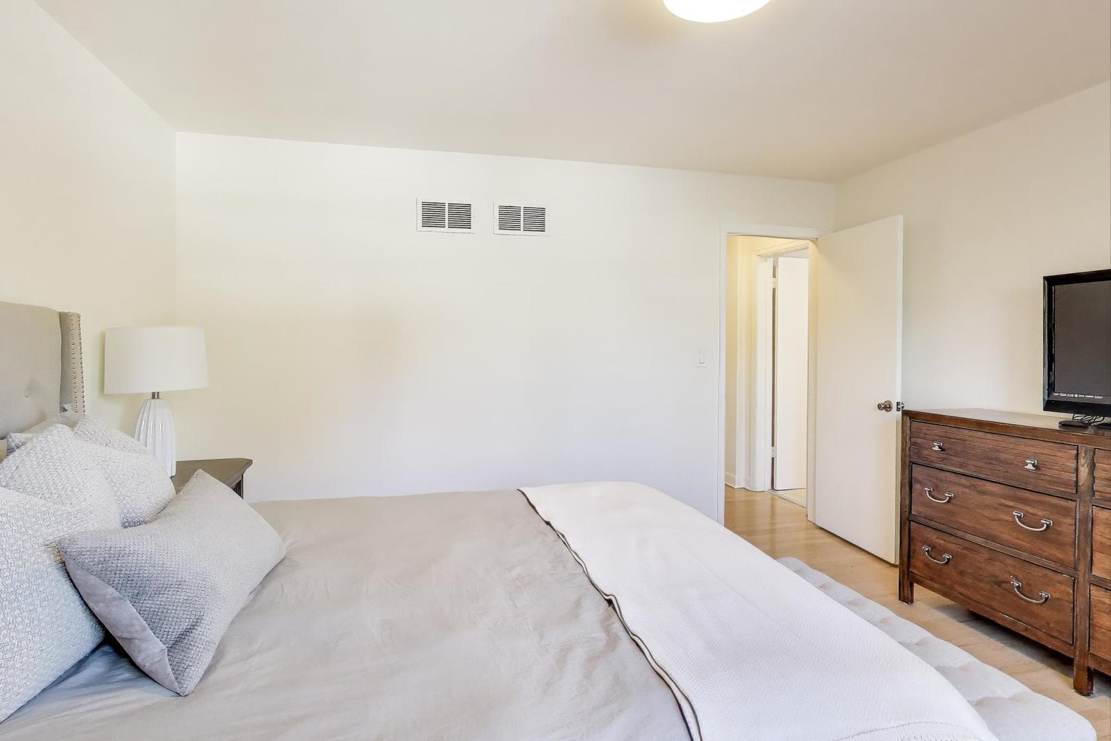 3131 Central Street Evanston, IL 60201 - Photo 12 of 28 a bedroom with a bed and a television