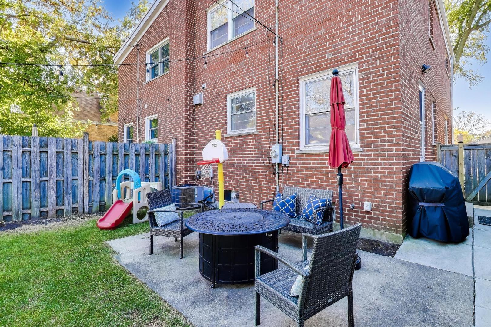 3131 Central Street Evanston, IL 60201 - Photo 23 of 28 a backyard of a house with barbeque oven table and chairs